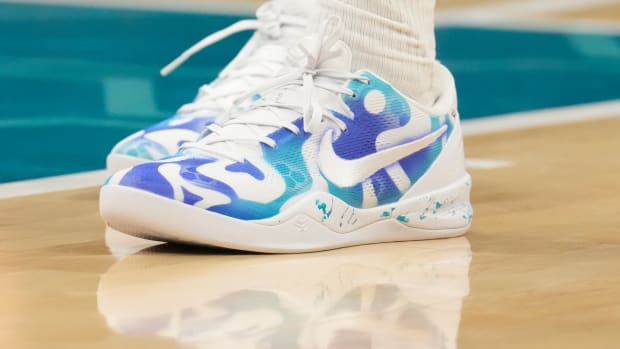 Charlotte Hornets forward Brandon Miller's white and teal Nike shoes.